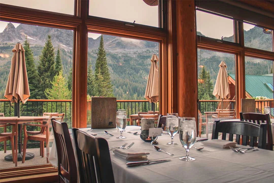Set tables and mountain views in Tamarack’s dining room