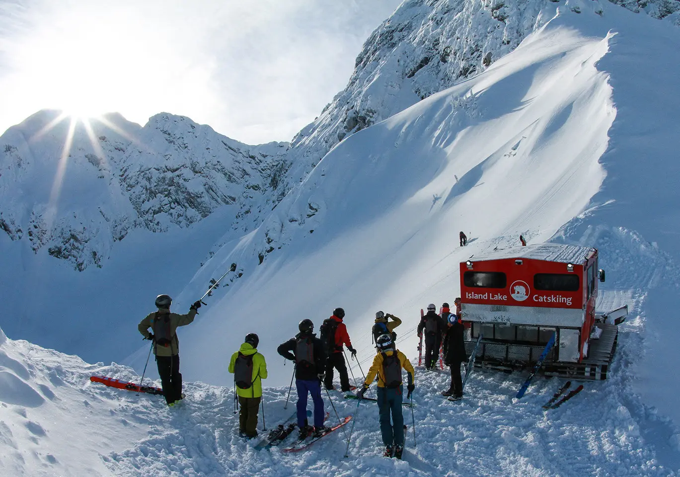 Guests gather beside their snowcat before heading into the terrain