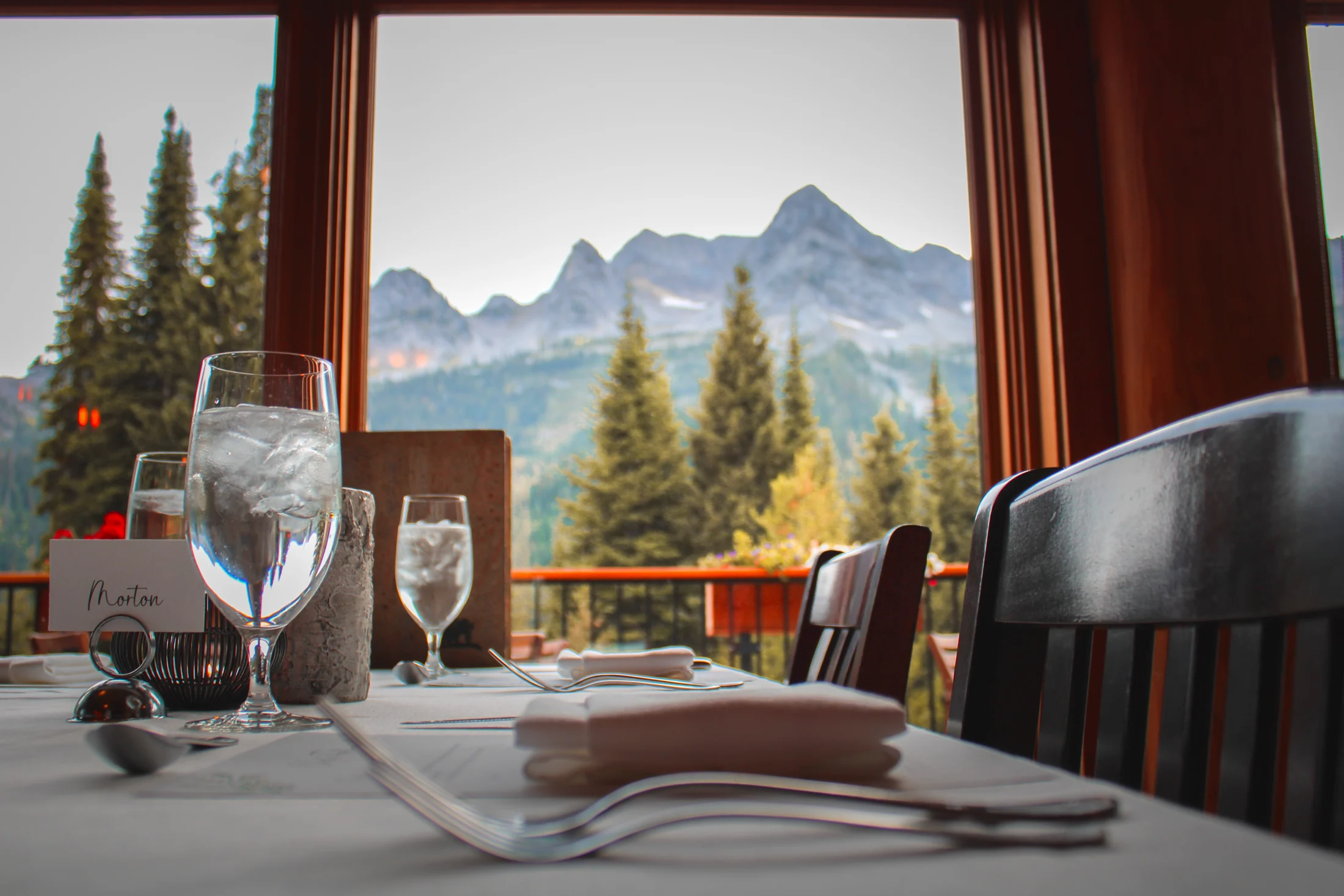 A table set for dinner overlooking the Lizard Range in Tamarack Dining Room