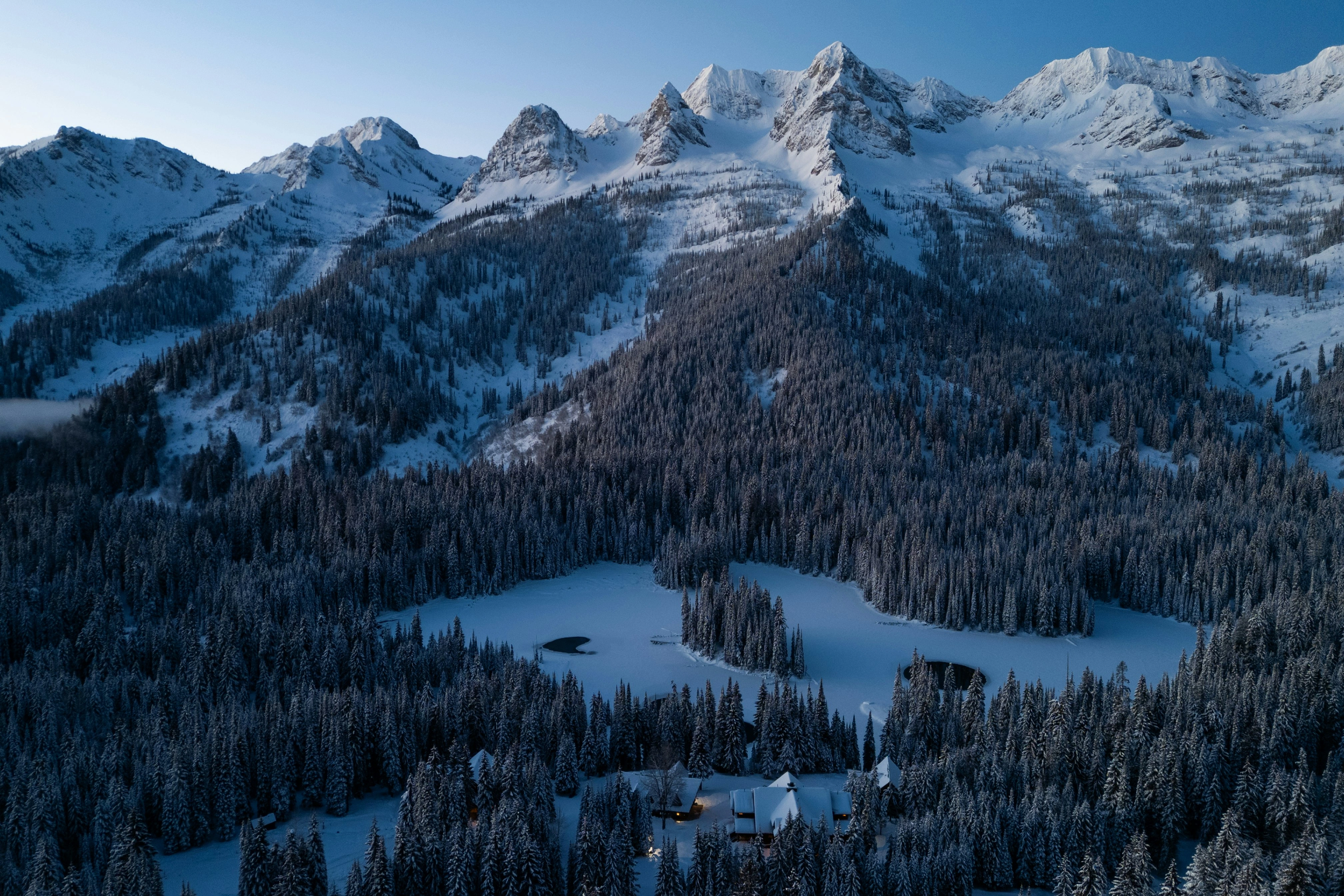 The Three Bears and alpine bowls above the frozen lake and snow-covered Cedar Valley