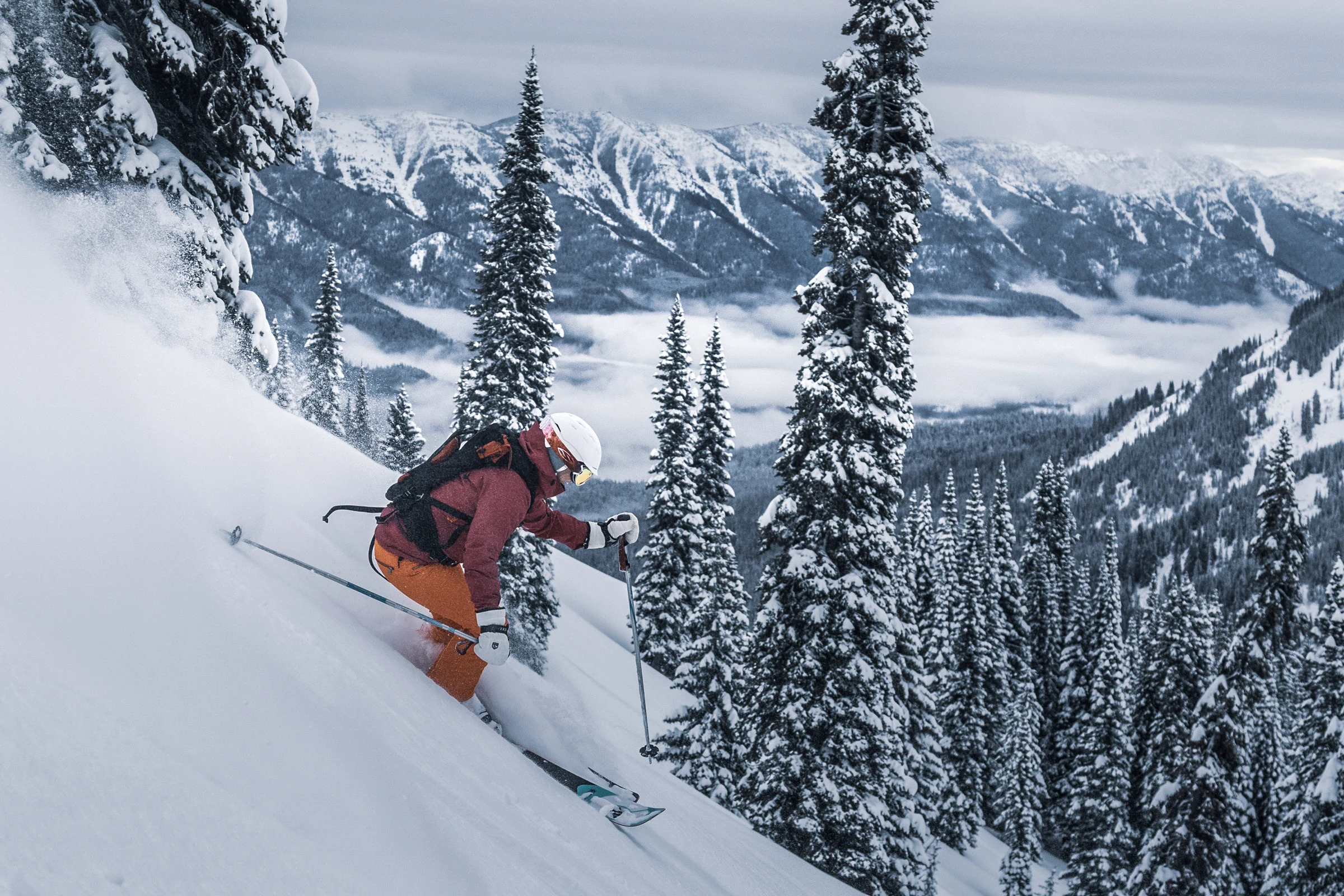 A skier turning through fresh powder at Island Lake