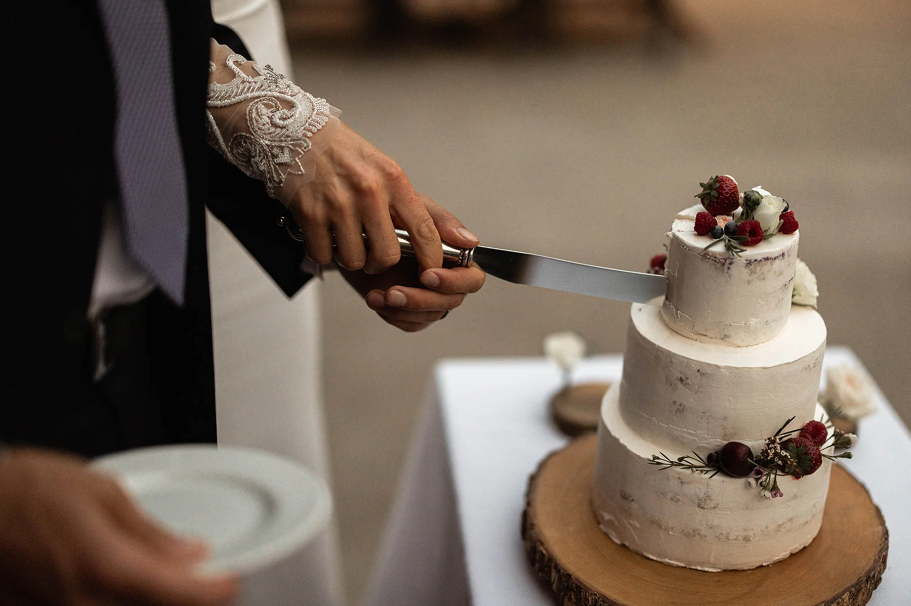 A wedding couple cutting their cake