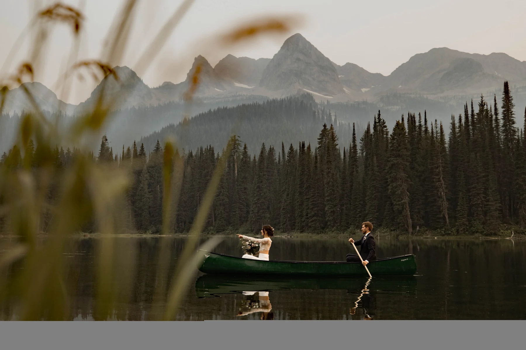 A wedding couple paddling a canoe on Island Lake