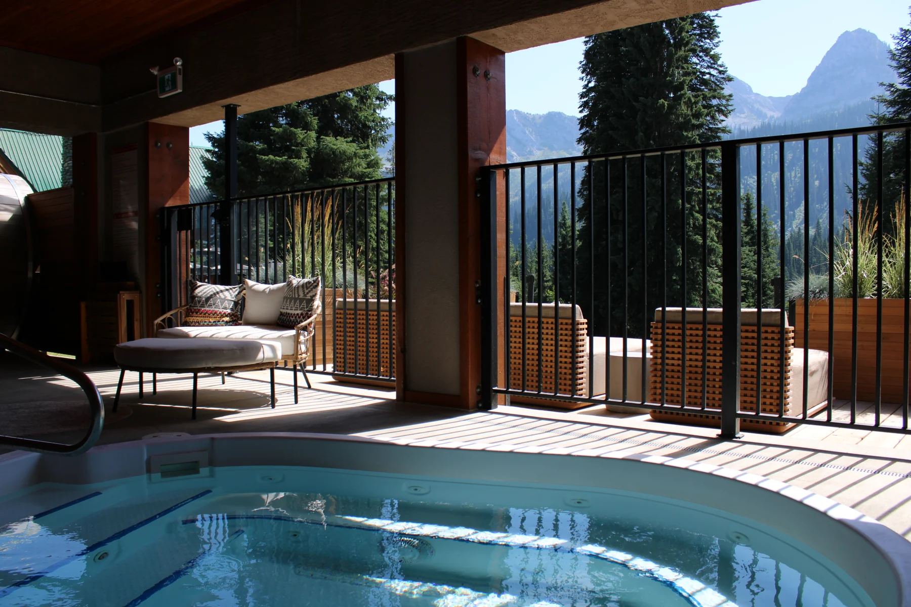 A hot pool and spa deck overlooking the mountains
